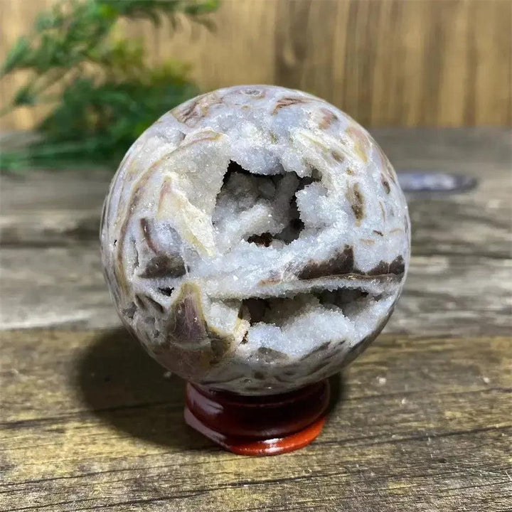 Unique Sphalerite Geode Sphere with Stand, showcasing raw crystal formations and grounding energy.