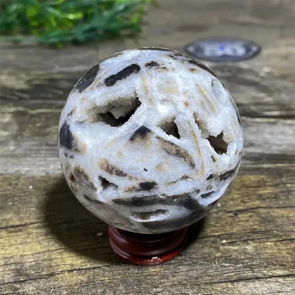 Sphalerite Sphere with Stand: White geode sphere with dark brown patterns, showcasing grounding energy and vitality.
