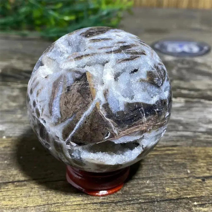 Sphalerite Sphere with Stand: Polished sphere with metallic luster, amber to dark brown tones, and white crystalline pockets.