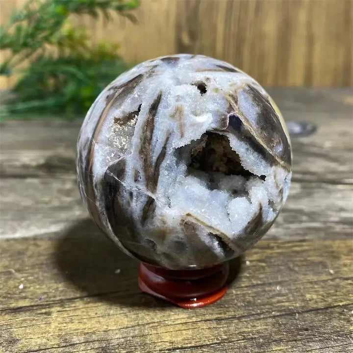 Polished Sphalerite Sphere with Stand, showcasing metallic luster, rich amber tones, and white crystalline geode pockets.