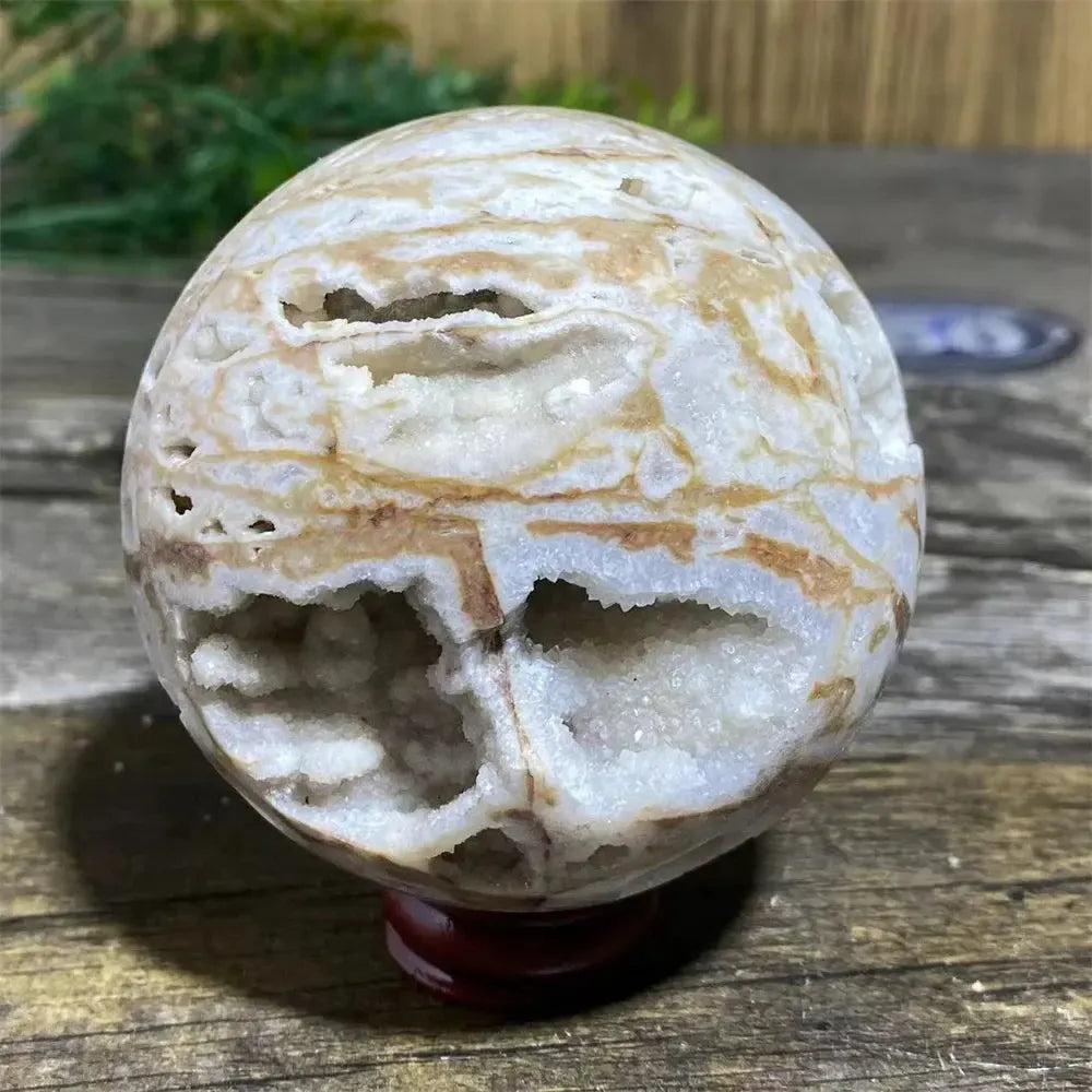 Polished Sphalerite sphere with metallic luster, rich amber tones, and natural variations on a display stand.