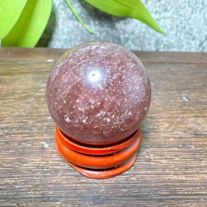 Polished 30mm Strawberry Quartz mini sphere featuring pink flecks and white snowflake clouds for Heart Chakra healing.