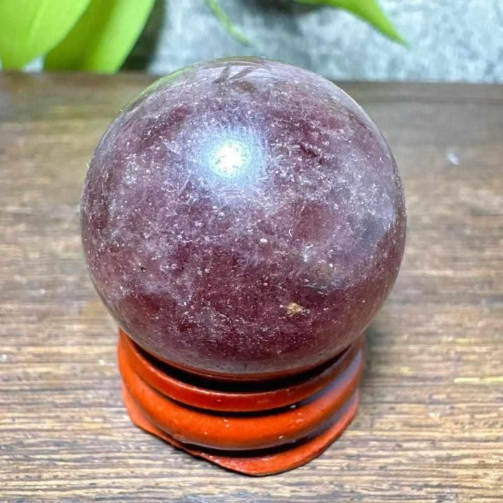 Polished 32mm Strawberry Quartz mini sphere featuring pink flecks and white snowflake clouds for heart chakra healing.