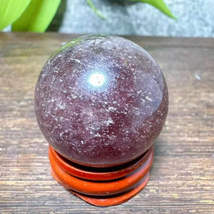 Polished 30-32mm Strawberry Quartz mini sphere featuring red, pink flecks and white snowflake clouds for heart chakra joy.