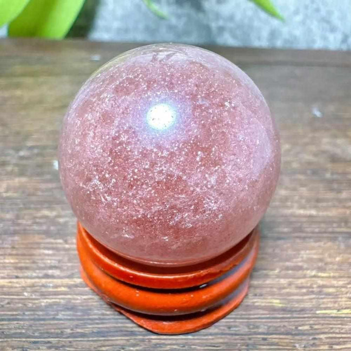 Polished 30-32mm Strawberry Quartz mini sphere featuring sparkling red, pink, and white snowflake inclusions for heart healing.