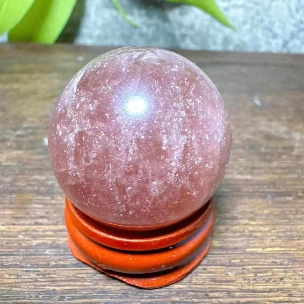 Polished 32mm Strawberry Quartz mini sphere with pink flecks and white snowflake clouds for Heart Chakra healing.