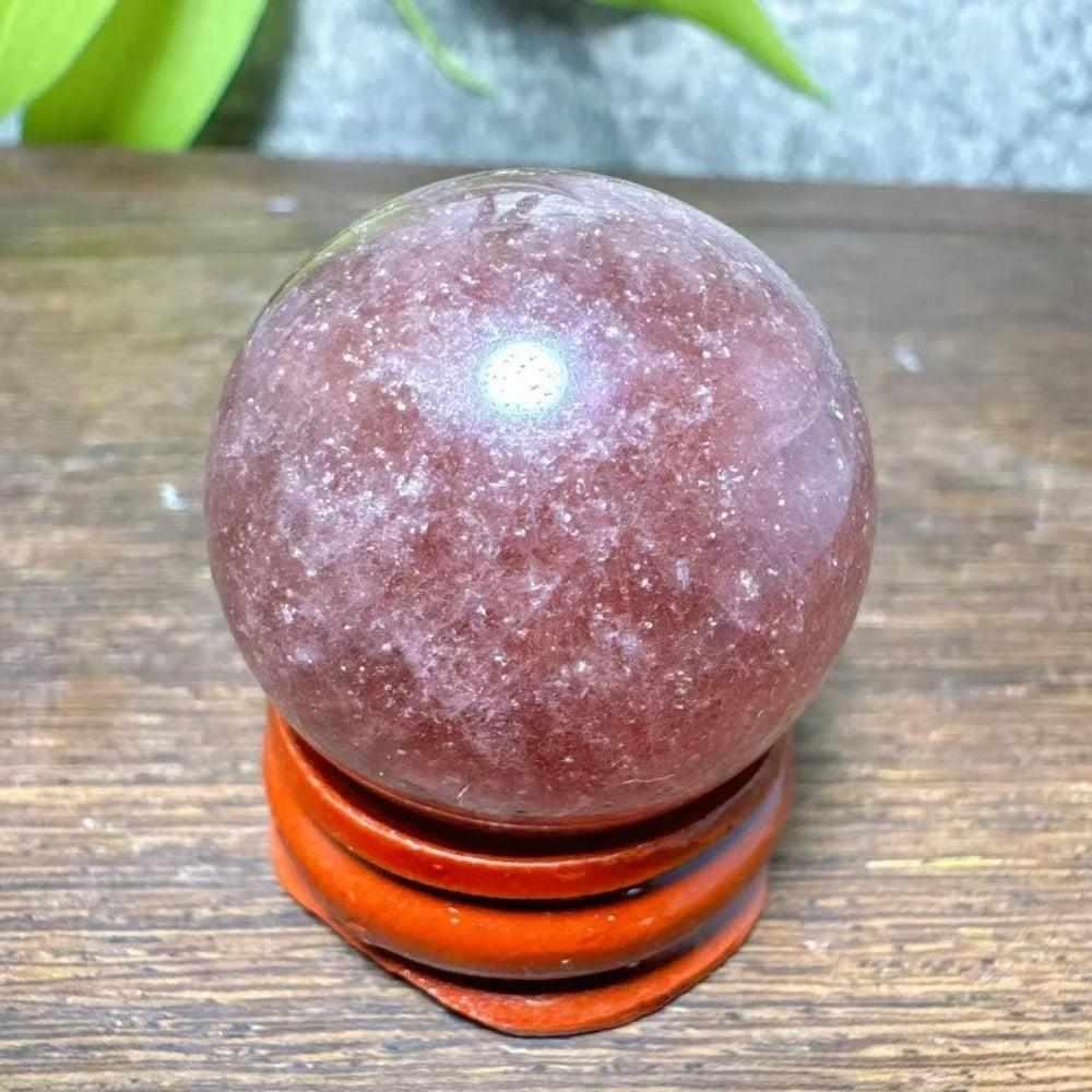 Polished 32mm Strawberry Quartz mini sphere featuring pink flecks and white snowflake clouds for heart chakra healing.