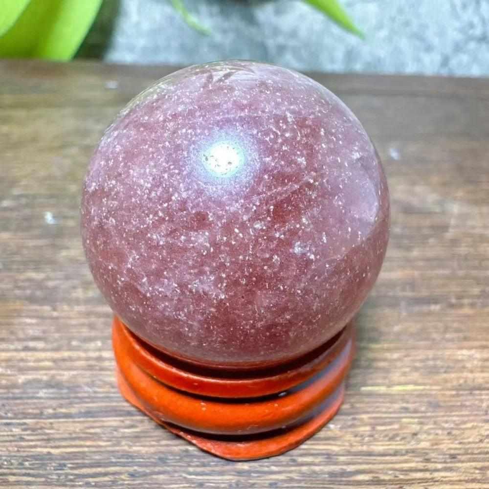 Polished 32mm Strawberry Quartz mini sphere featuring pink flecks and white snowflake clouds for heart chakra healing.