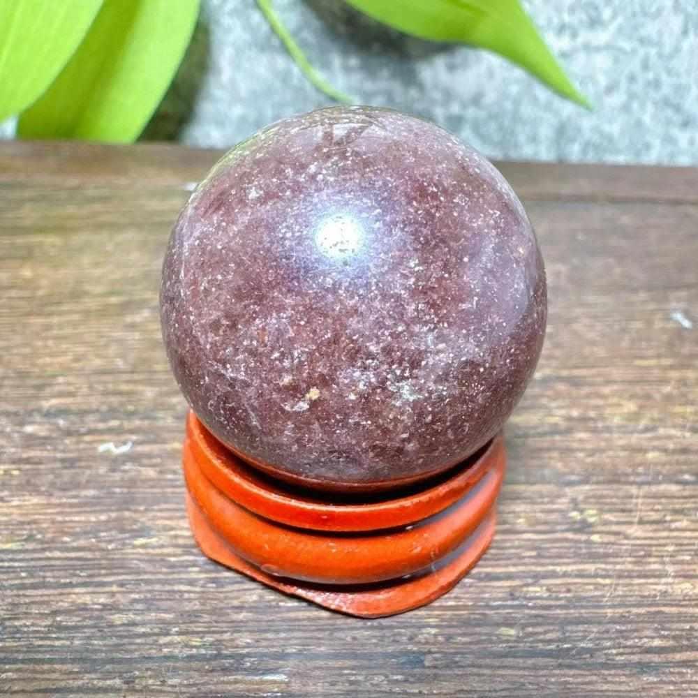 Polished 32mm Strawberry Quartz mini sphere featuring pink flecks and white snowflake clouds for heart chakra healing.