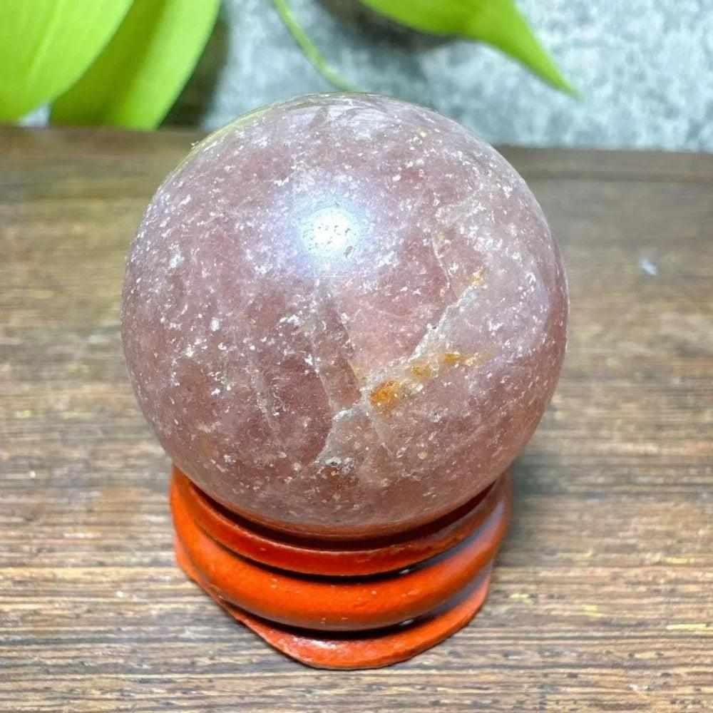 Polished 32mm Strawberry Quartz mini sphere with pink flecks and white snowflake clouds for heart chakra healing.