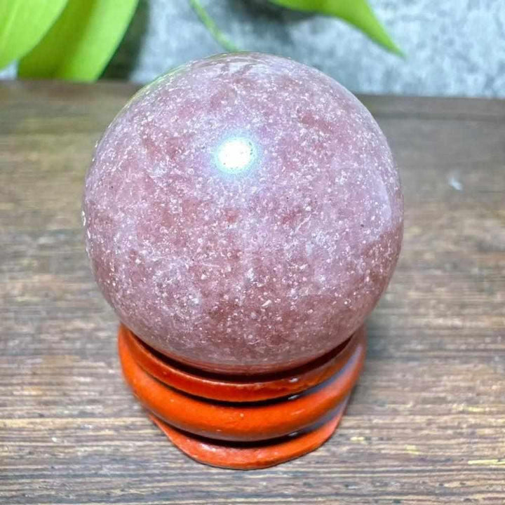 Polished 32mm Strawberry Quartz mini sphere featuring pink tones and white snowflake clouds for heart chakra healing.