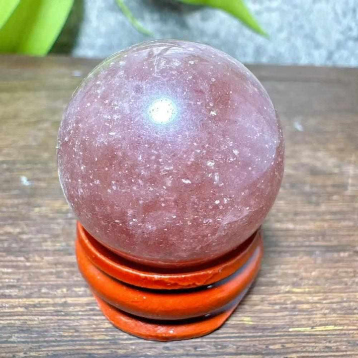 Polished 32mm Strawberry Quartz mini sphere featuring pink hues and white snowflake clouds for heart chakra healing.