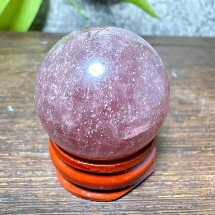 Polished 32mm Strawberry Quartz mini sphere featuring pink hues and white snowflake clouds for Heart Chakra healing.