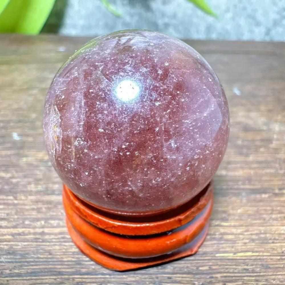 Polished 32mm Strawberry Quartz mini sphere featuring pink flecks and white snowflake clouds for Heart Chakra healing.