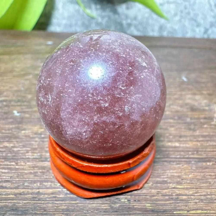 Polished 32mm Strawberry Quartz mini sphere featuring pink flecks and white snowflake clouds for heart chakra healing.