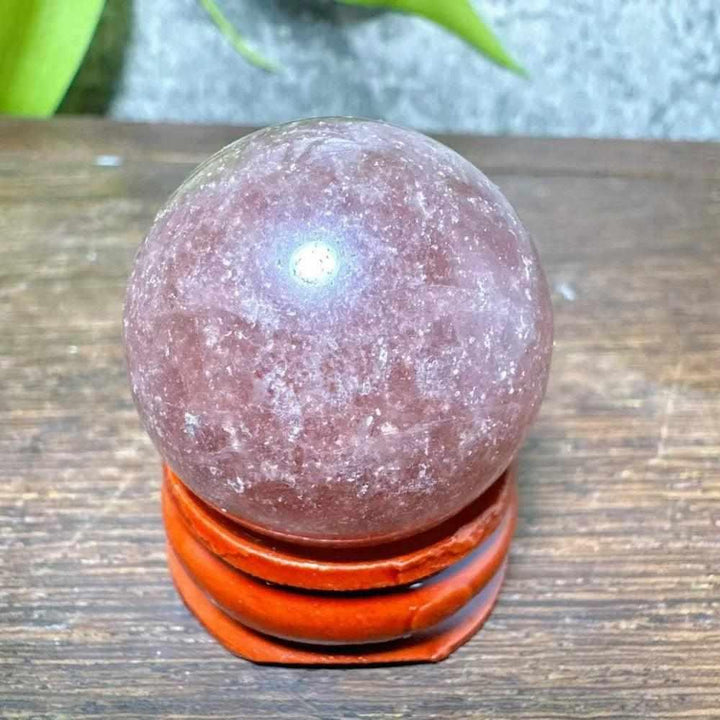 Polished 32mm Strawberry Quartz mini sphere featuring pink-red flecks and white snowflake clouds for heart chakra healing.