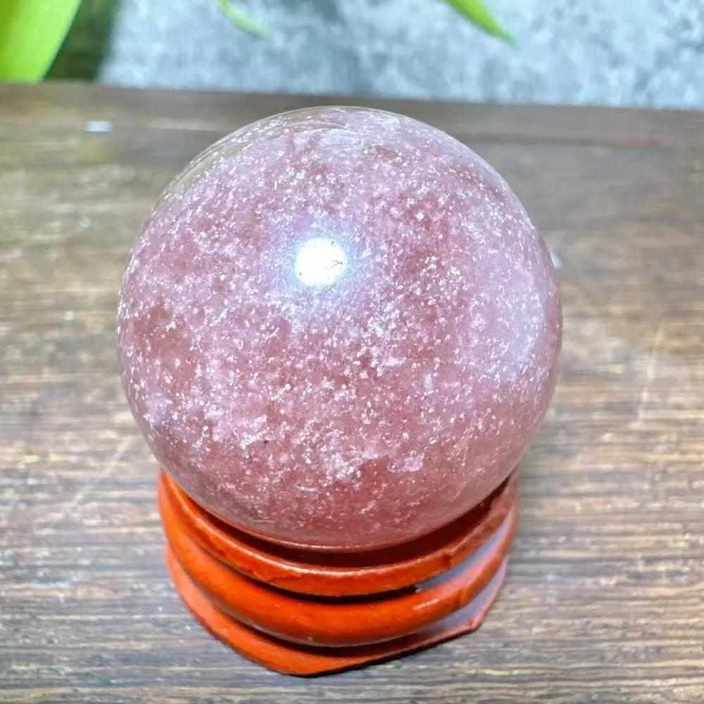 Polished 30mm Strawberry Quartz mini sphere featuring pink hues and white snowflake clouds for heart chakra healing.