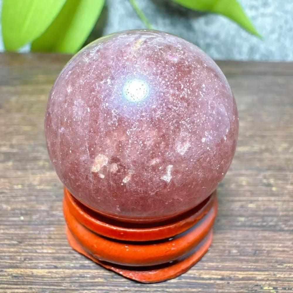 Polished 30-32mm Strawberry Quartz mini sphere with pink flecks and white snowflake clouds for Heart Chakra healing.