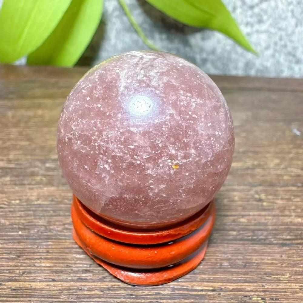 Polished 32mm Strawberry Quartz mini sphere featuring pink tones and white snowflake clouds for heart chakra healing.