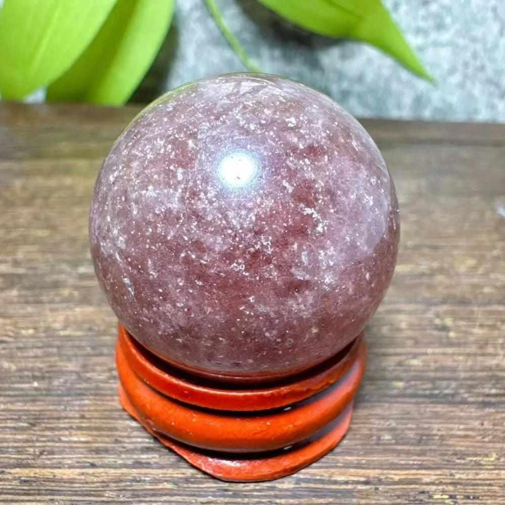 Polished 32mm Strawberry Quartz mini sphere with pink flecks and white snowflake clouds for heart chakra healing.
