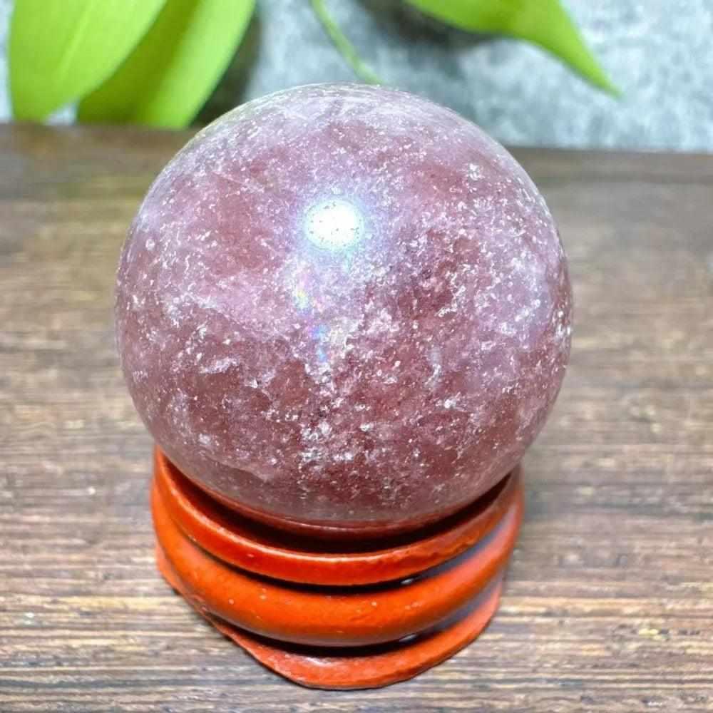 Polished 32mm Strawberry Quartz mini sphere featuring pink flecks and white snowflake clouds for heart chakra healing.