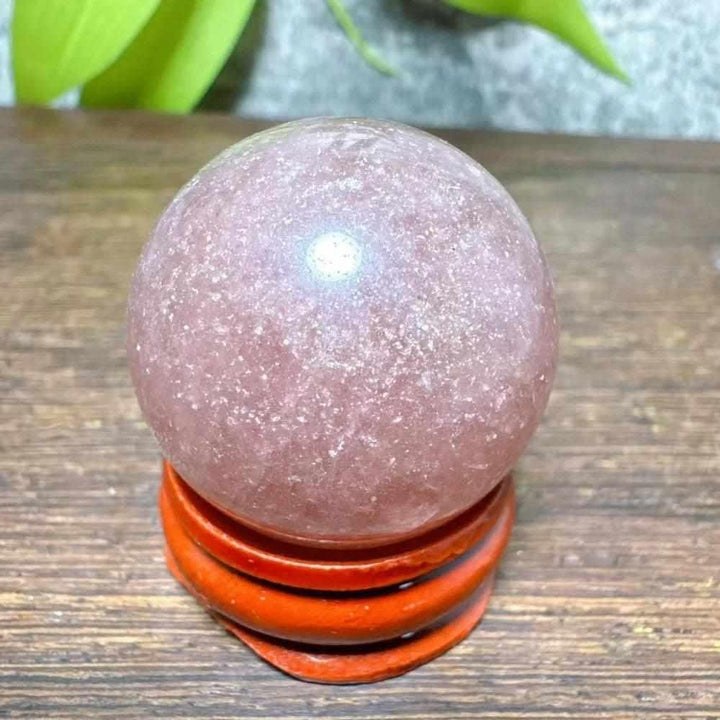 Polished 32mm Strawberry Quartz mini sphere with pink flecks and white snowflake clouds for Heart Chakra healing.
