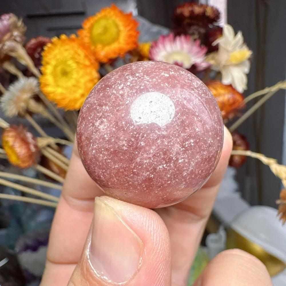 Polished 30mm Strawberry Quartz mini sphere with pink flecks and white snowflake clouds for heart chakra healing.