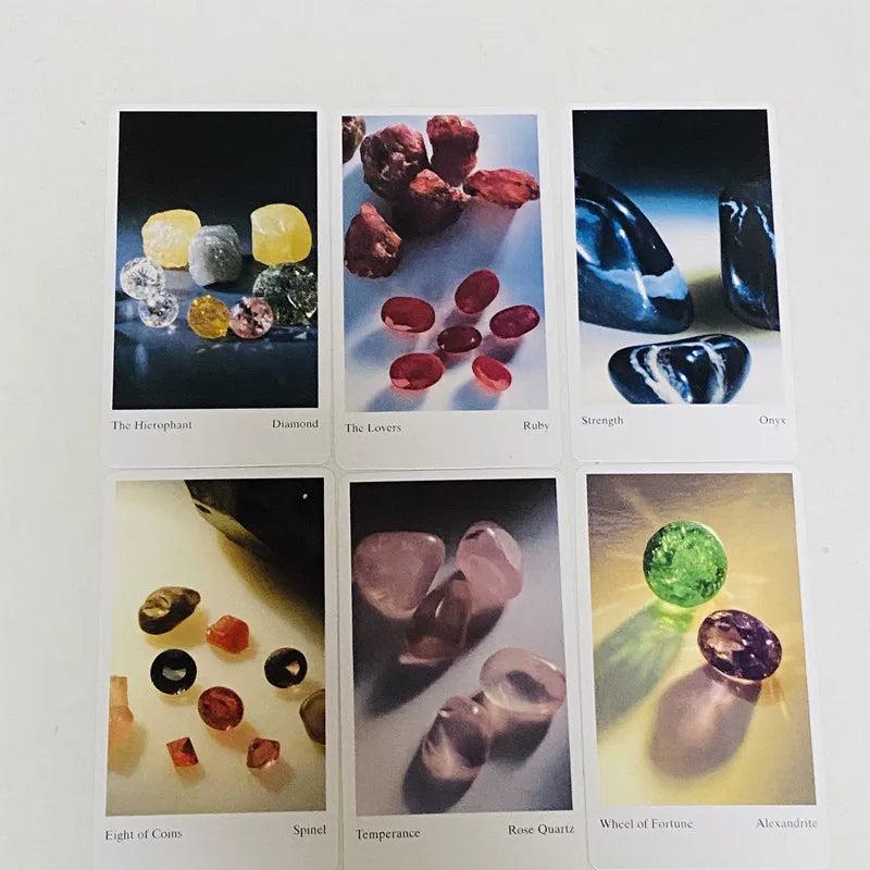 Six tarot cards featuring vibrant gemstone imagery: diamond, ruby, onyx, spinel, rose quartz, and alexandrite.