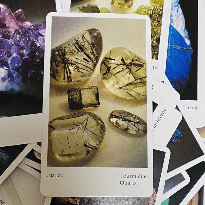 Tarot card featuring clear, polished tourmaline quartz with black needle inclusions, labeled "Justice.
