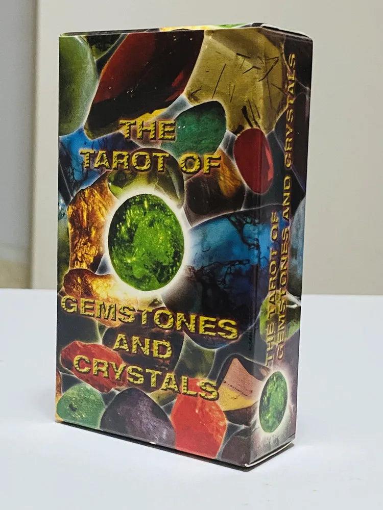 Tarot of Gemstones and Crystals deck box featuring a vibrant collage of colorful, polished stones and a glowing green crystal.