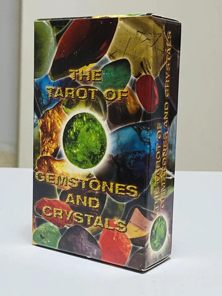 Tarot of Gemstones and Crystals deck box featuring a vibrant collage of colorful, polished stones and a glowing green crystal.
