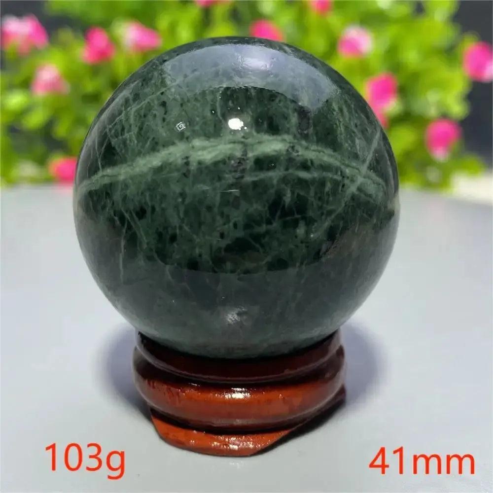Polished dark green Tibetan Jade Crystal Sphere on a wooden stand, 41mm, from Crystal Destiny.