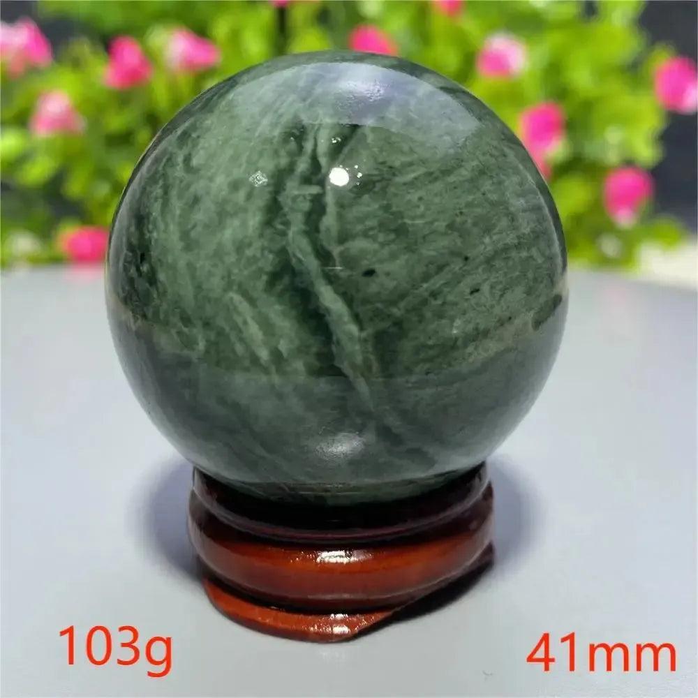 Polished dark green Tibetan Jade Crystal Sphere (41mm, 103g) on a wooden stand from Crystal Destiny.
