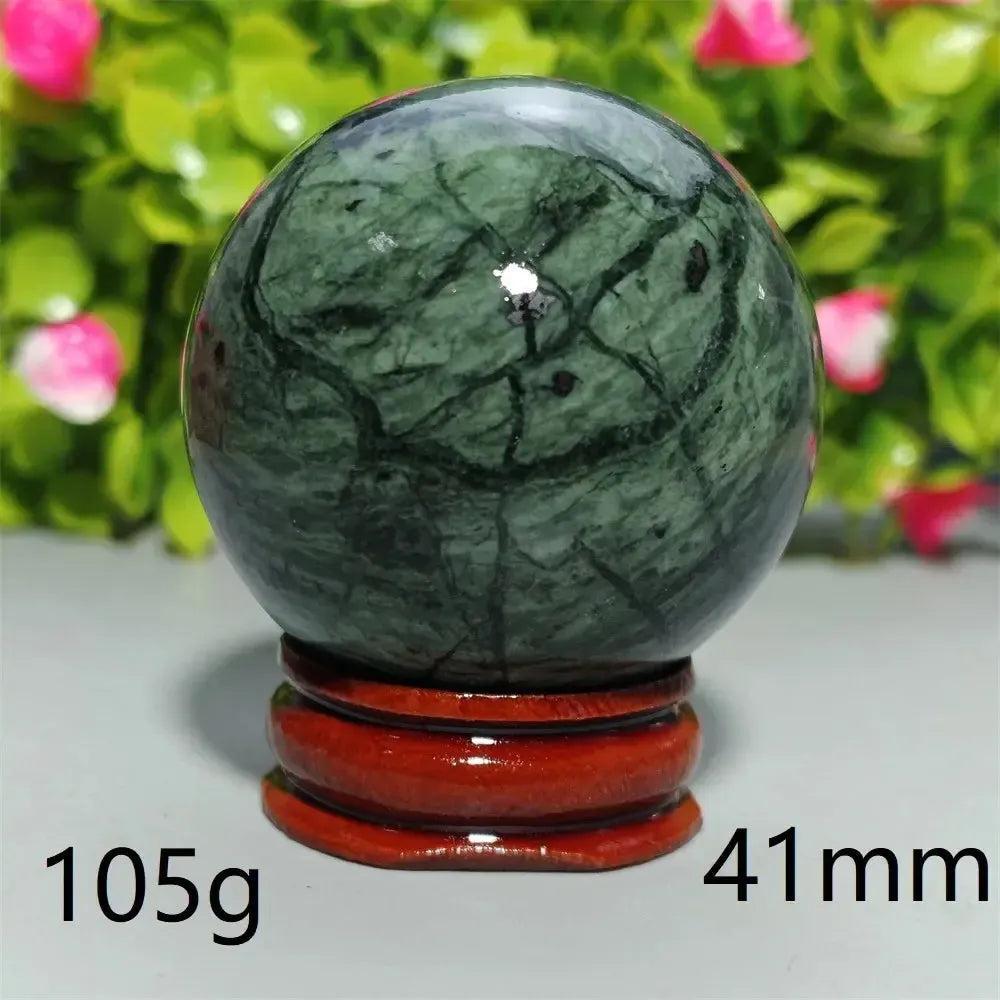 Polished dark green Tibetan Jade Crystal Sphere (41mm, 105g) on a wooden stand from Crystal Destiny.