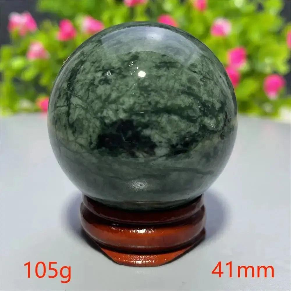 Smooth, polished dark green Tibetan Jade Crystal Sphere (41mm, 105g) on a wooden stand from Crystal Destiny.