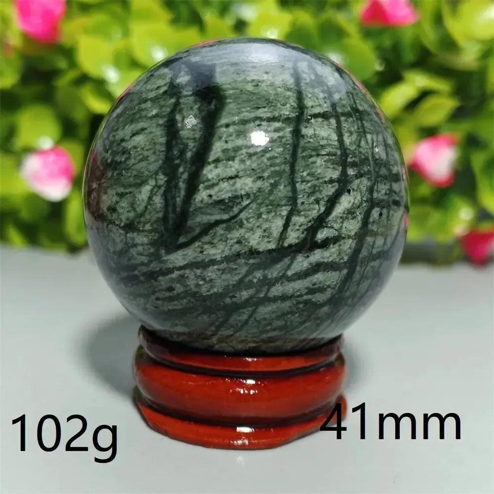 Polished dark green Tibetan Jade Crystal Sphere (41mm, 102g) on a red stand, promoting calm and balance.