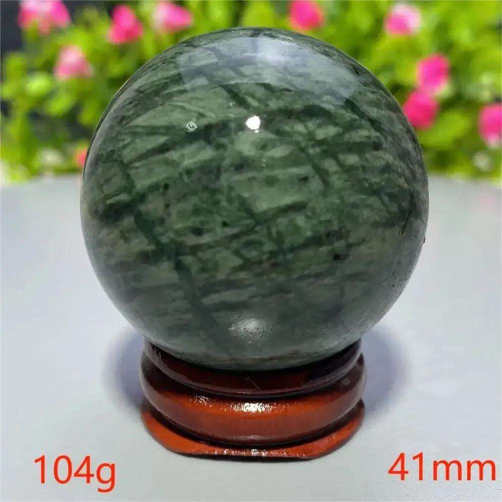 Smooth, polished dark green Tibetan Jade Crystal Sphere (41mm, 104g) on a wooden stand from Crystal Destiny.