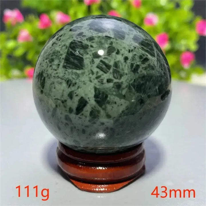 Polished dark green Tibetan Jade crystal sphere on a wooden stand, 43mm, 111g, from Crystal Destiny.