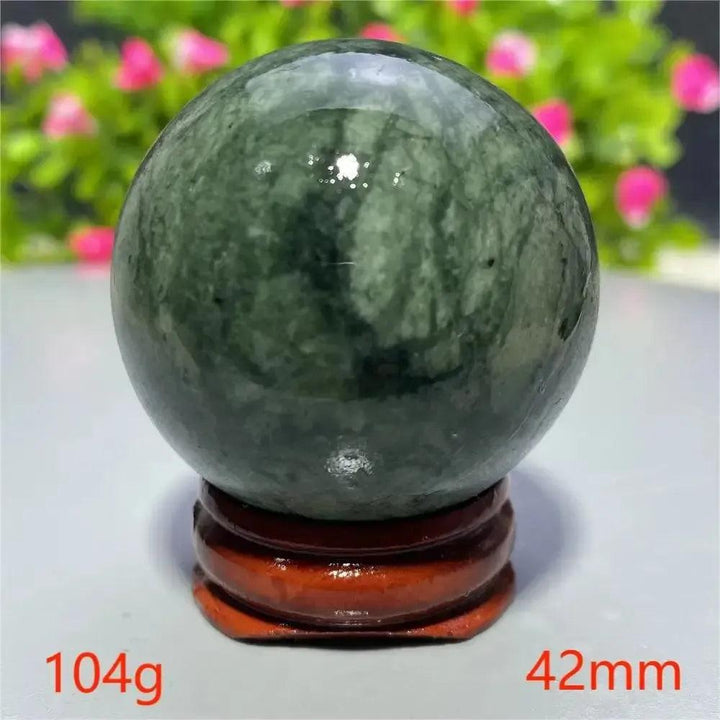 Smooth, polished dark green Tibetan Jade Crystal Sphere on a wooden stand, 104g, 42mm. Crystal Destiny.