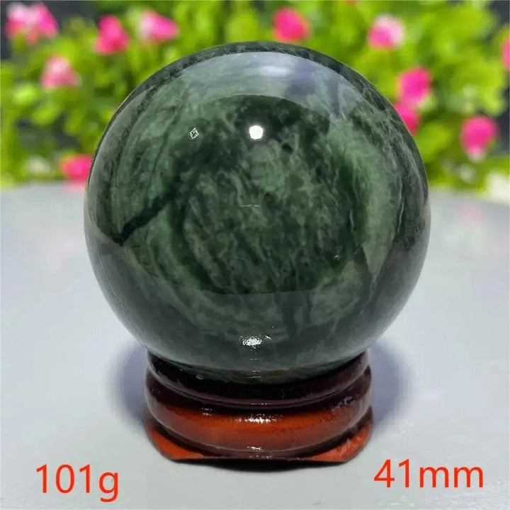 Smooth, polished dark green Tibetan Jade Crystal Sphere (41mm, 101g) on a wooden stand from Crystal Destiny.