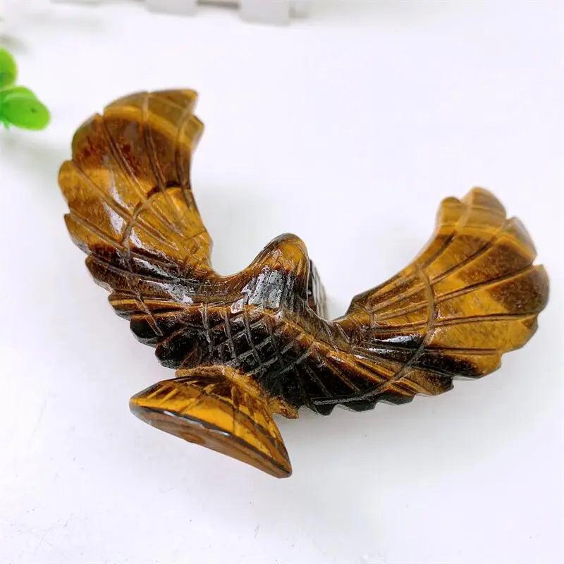 Hand-carved Tiger Eye spinning eagle statue with golden chatoyant bands for grounding, stability, and manifestation.