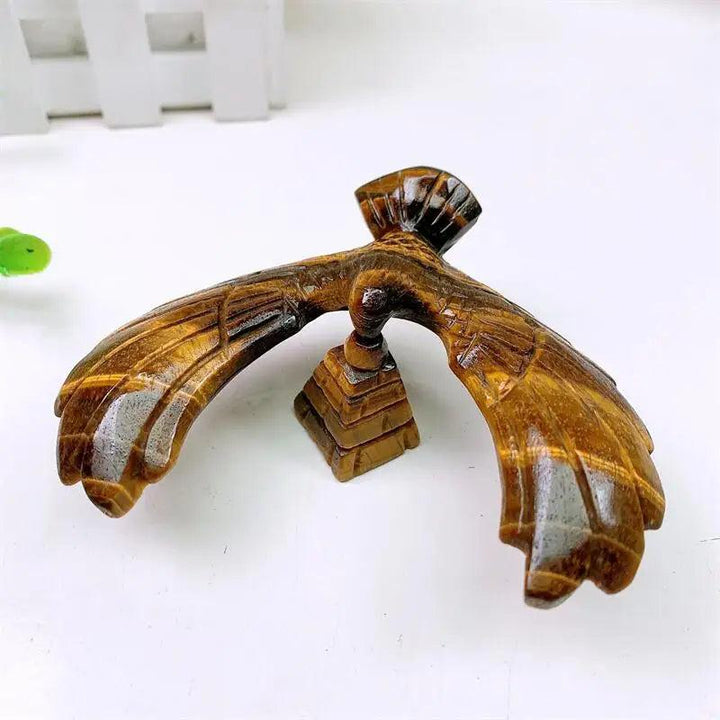Hand-carved Tiger Eye spinning eagle statue on a pyramid base, featuring golden chatoyant bands for grounding energy.