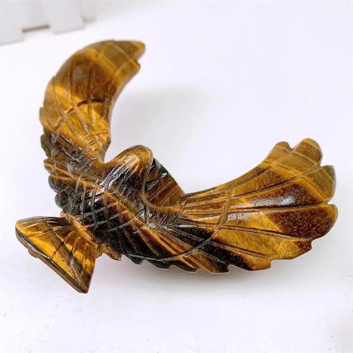 Hand-carved Tiger Eye spinning eagle statue with golden chatoyant bands, designed for grounding and balanced meditation.