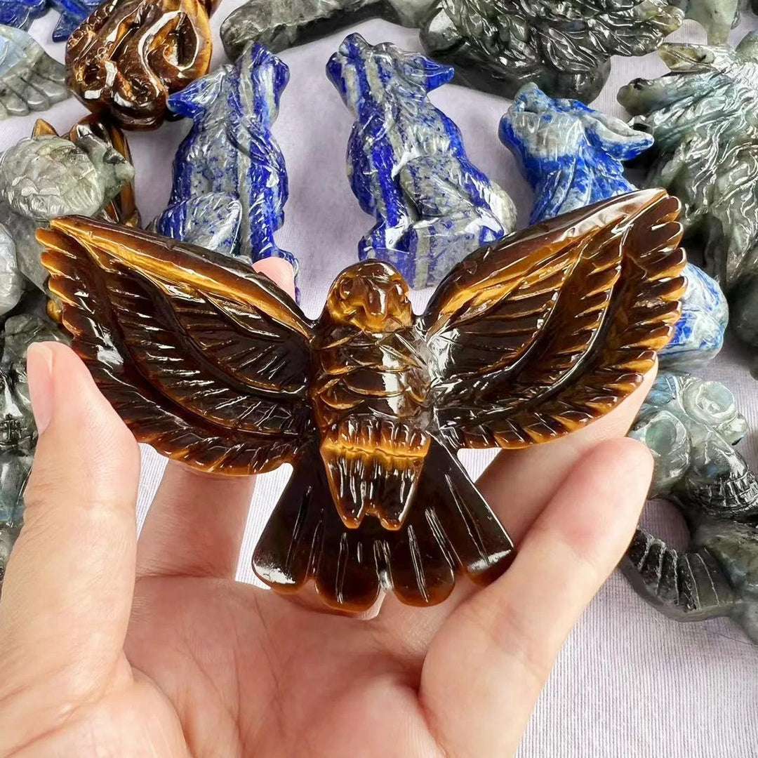 Hand-carved Tiger Eye eagle statue with golden chatoyant bands, promoting confidence, courage, and grounding energy.