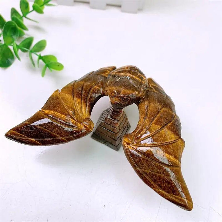 Tiger Eye Crystal Carved Spinning Bat with Pyramid Sculpture, showcasing warm golden chatoyancy for protection and confidence.