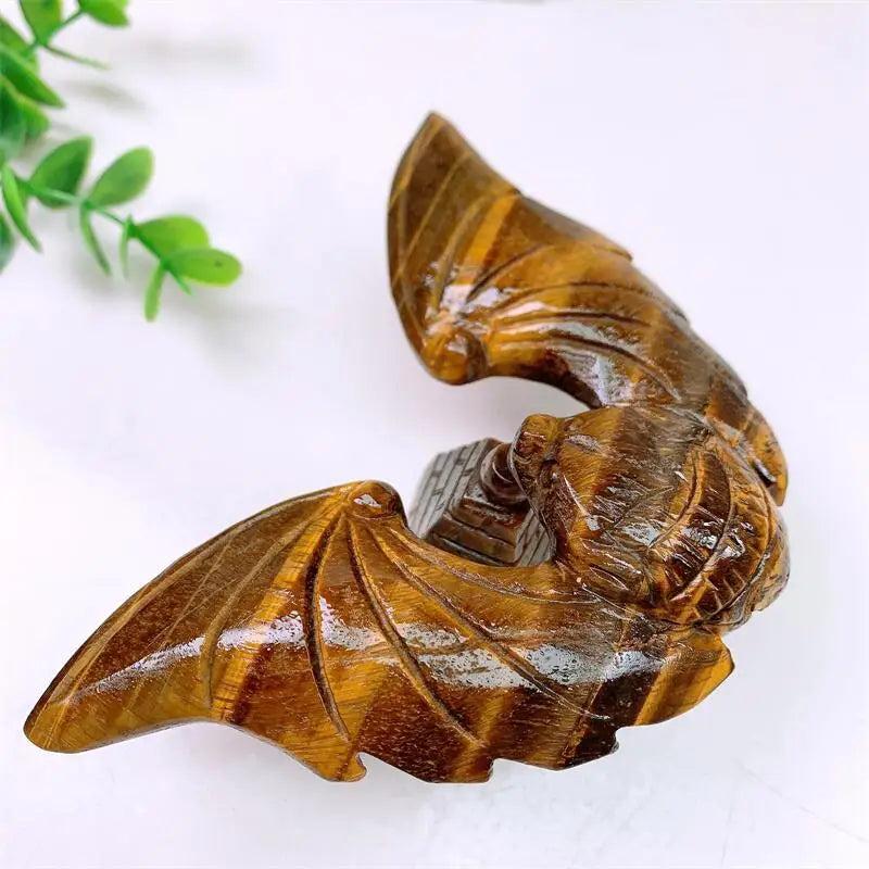 Tiger Eye Crystal Carved Spinning Bat with Pyramid Sculpture, showcasing warm golden chatoyancy for protection and confidence.