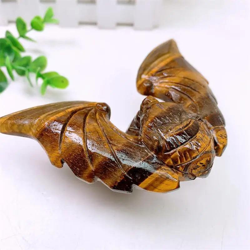 Tiger Eye Crystal Carved Spinning Bat with Pyramid Sculpture, showcasing warm golden chatoyancy for protection and confidence.