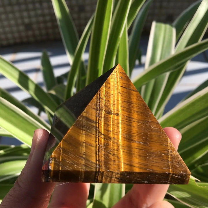 50mm polished natural Tiger Eye crystal pyramid with golden-brown chatoyant bands for healing and Feng Shui energy.
