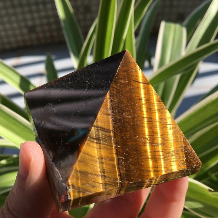 50mm polished natural Tiger Eye crystal pyramid, featuring golden-brown chatoyant bands for healing and Feng Shui energy.