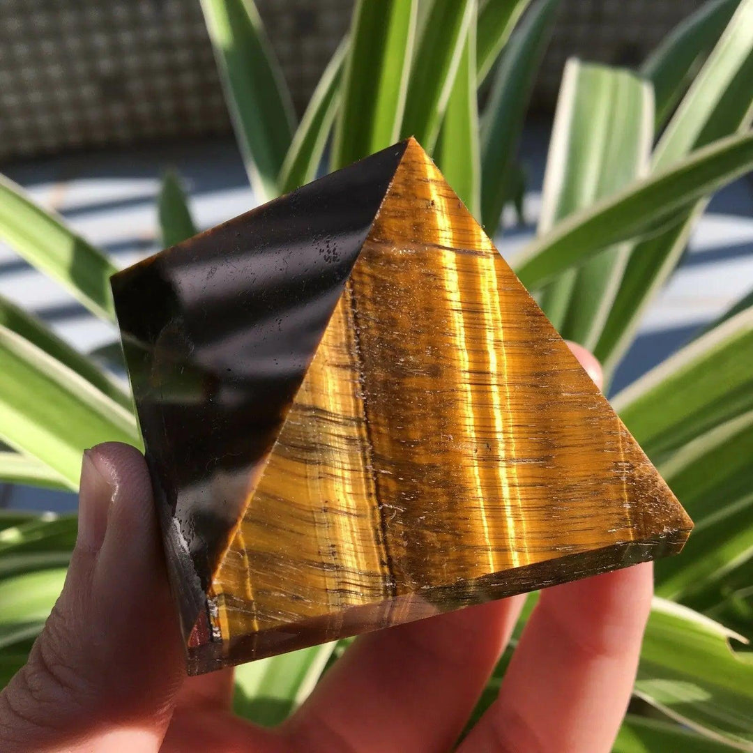 50mm natural Tiger Eye crystal pyramid with polished golden-brown bands for Reiki healing and Feng Shui energy.